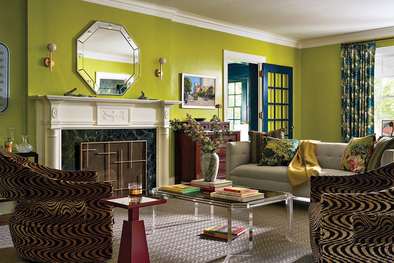 vibrant green-walled living room with textiles in a range of patterns